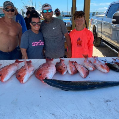 a group of people standing in front of a fish