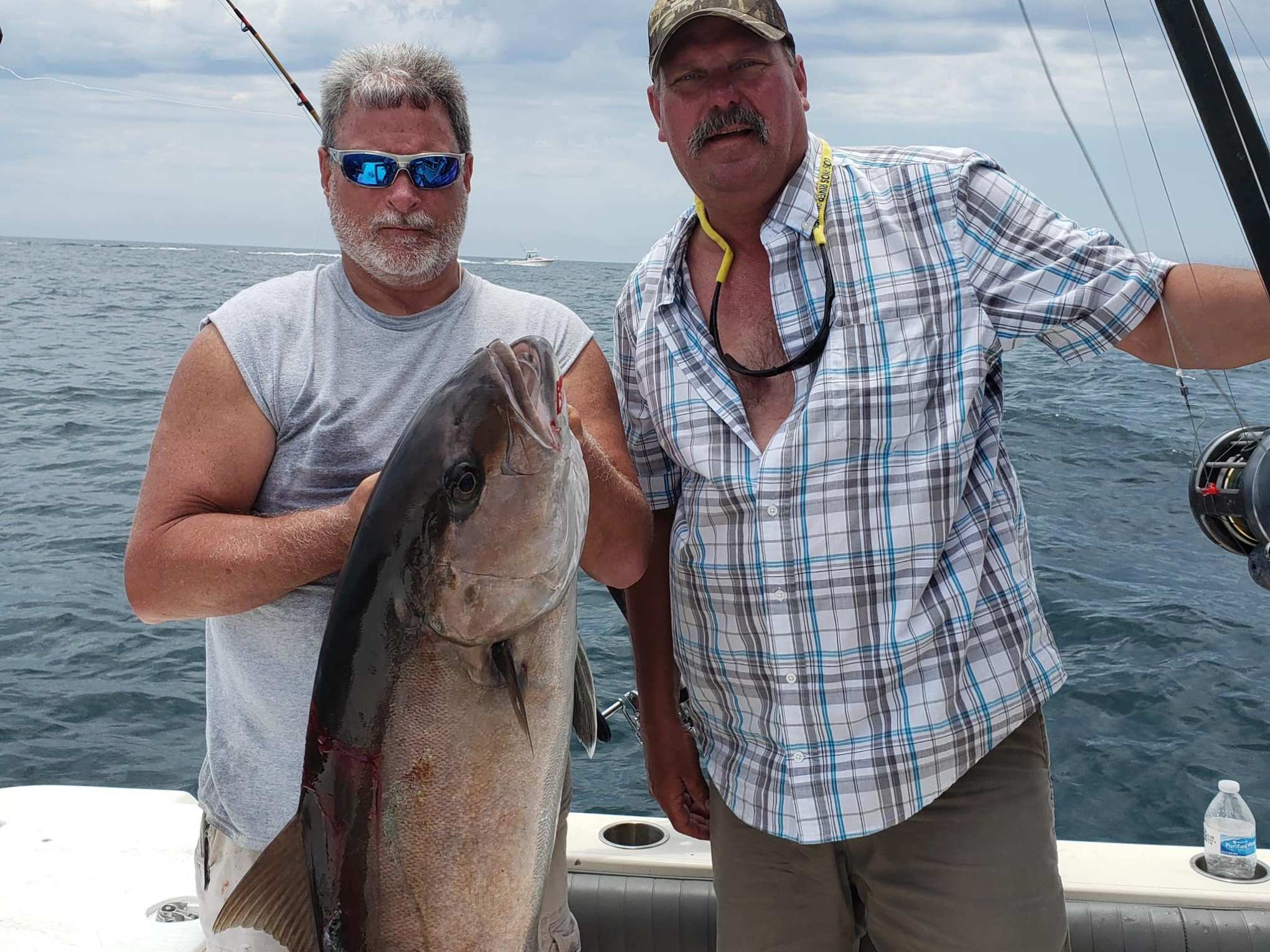 a man holding a fish in the water