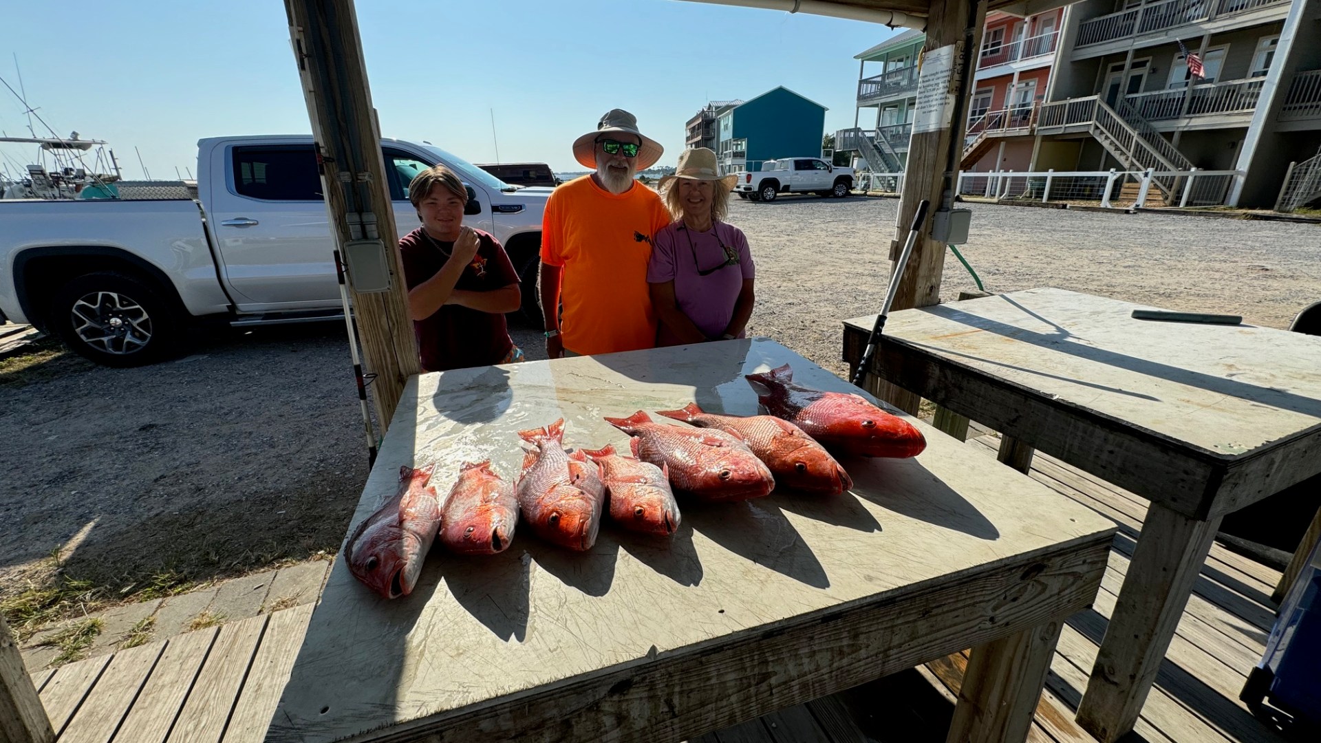 a group of people sitting around a wooden table