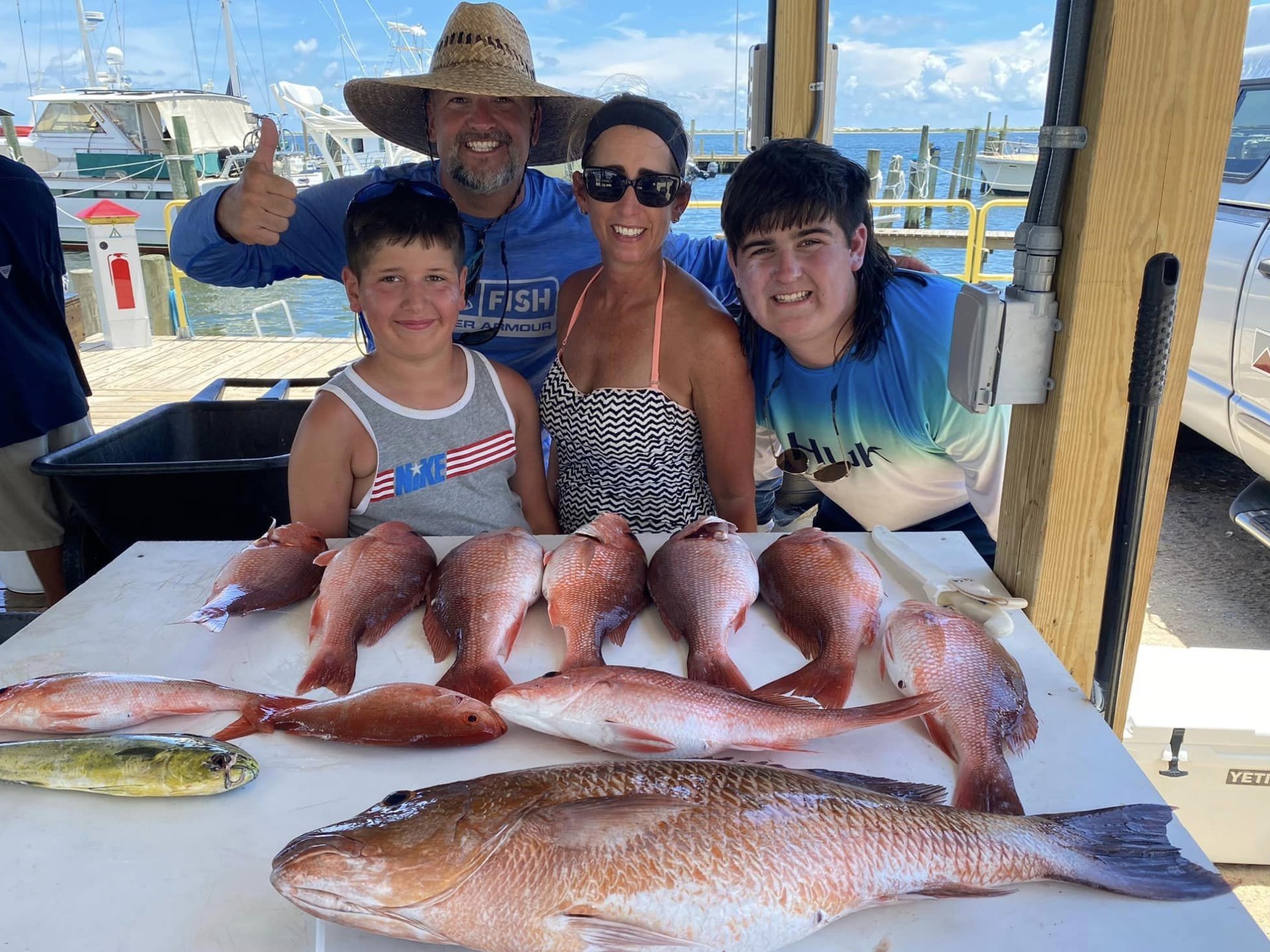 a person holding a fish on a boat