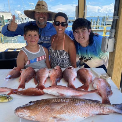 a person holding a fish on a boat